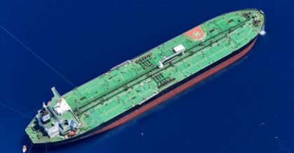 Aerial shot of an oil tanker sailing in the ocean near Vado Ligure, Italy.